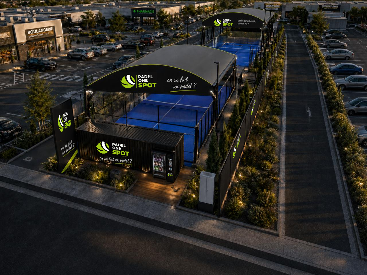 Vue aérienne du Padel One Spot en soirée avec terrains éclairés